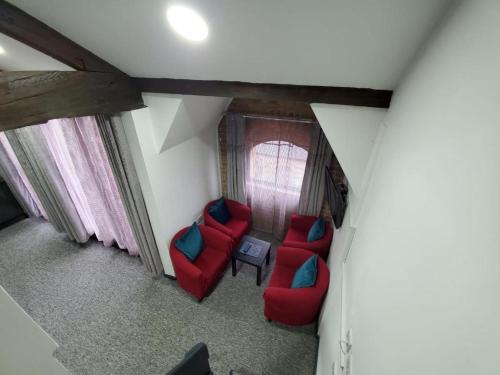 an overhead view of a living room with red chairs at Trivelles Regency, Nottingham in Nottingham