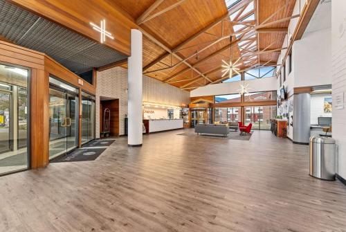 an empty lobby of a building with wooden ceilings at Ramada by Wyndham Cedar City in Cedar City