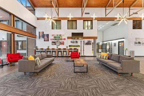 a living room with couches and a dining room at Ramada by Wyndham Cedar City in Cedar City