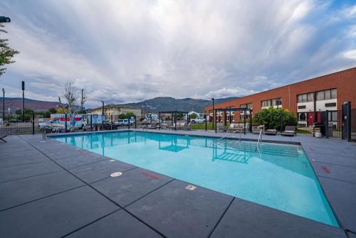 a large swimming pool in front of a building at Ramada by Wyndham Cedar City in Cedar City