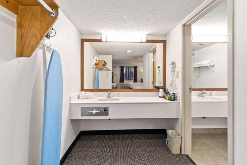 a bathroom with two sinks and a large mirror at Ramada by Wyndham Cedar City in Cedar City