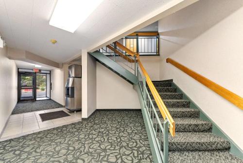 a staircase in a house with a stair case at Ramada by Wyndham Cedar City in Cedar City