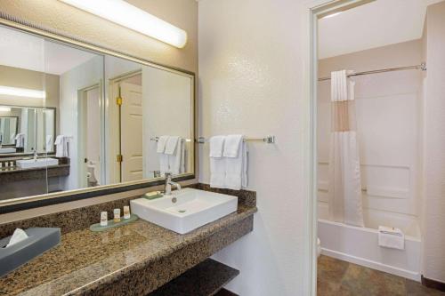 a bathroom with a sink and a mirror at La Quinta by Wyndham Las Vegas RedRock/Summerlin in Las Vegas