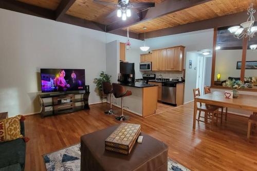a living room with a couch and a table and a kitchen at Entire one bedroom apartment in Annandale