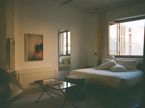 a bedroom with a bed and a table in it at Mona Athens in Athens