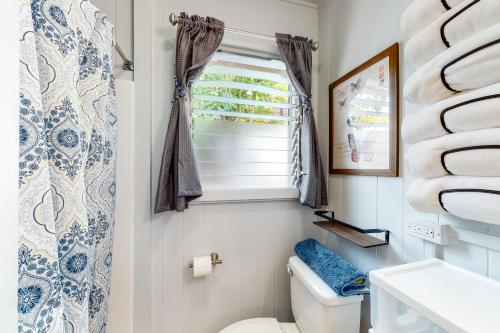 ein Bad mit einem WC und einem Fenster in der Unterkunft Monsarrat Apt D - 30-Night Minimum in Honolulu