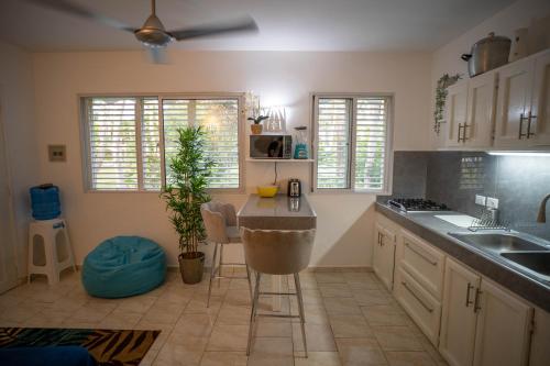 a kitchen with a sink and a table in it at Charming 1 bdr apt w/ pool 5min Popi beach in Las Terrenas