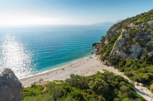 a view of a beach with people on it at Villa Settimia a 50 mt dalla spiaggia! in Àrbatax