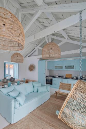 a living room with a couch and a table at Casa Azul do Olival in Alcácer do Sal