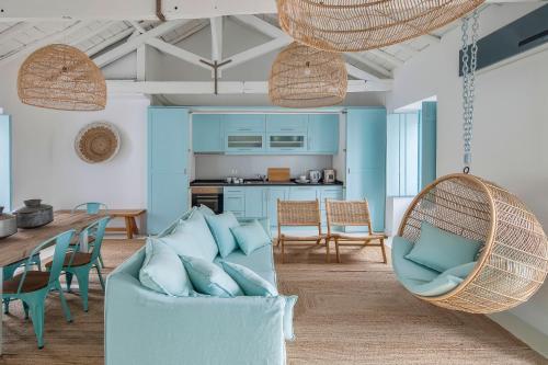 a living room with a swing chair and a table at Casa Azul do Olival in Alcácer do Sal