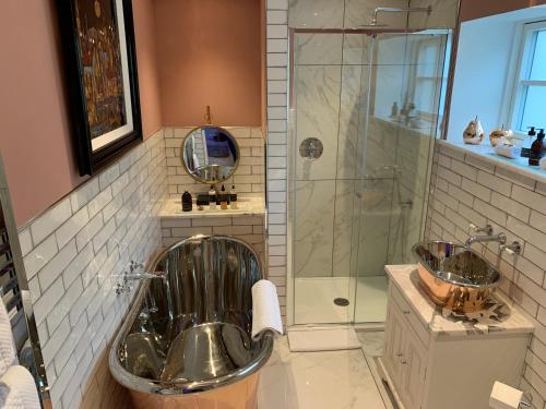 a bathroom with a tub and a shower and a sink at Little Fox Lodge Luxury Hideaway with Hot Tub Glencoe Near Fortwilliam in Glencoe