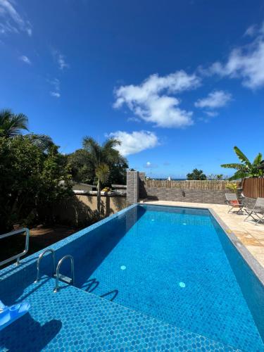 a swimming pool with a blue sky in the background at The Runway Lodge in Pointe Larue