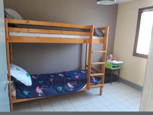 a bedroom with two bunk beds with a ladder at Ombre d'été in Ruoms