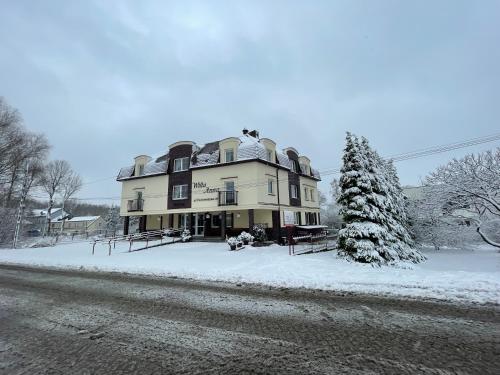 a large house in the snow on a street at Willa Anna - Pokoje Gościnne in Goczałkowice-Zdrój