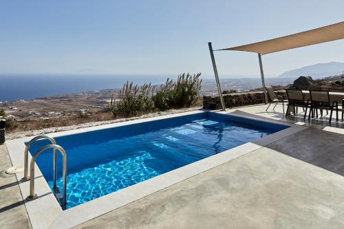 a swimming pool with a view of the ocean at Theano Cave Suites & Villas in Imerovigli