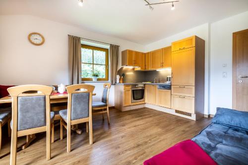 a kitchen and dining room with a table and chairs at Appartement Angerhaus in Kleinarl