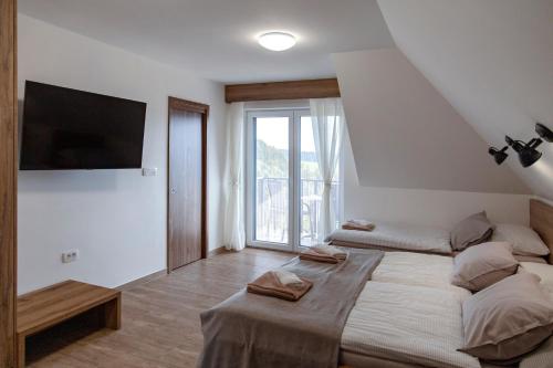 a bedroom with a large bed and a large window at Vila Marin Miler in Prevalje