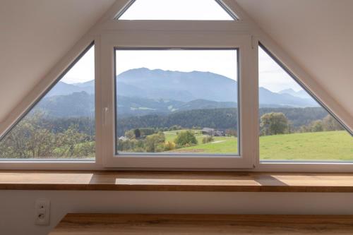 a window in a room with a view of mountains at Vila Marin Miler in Prevalje