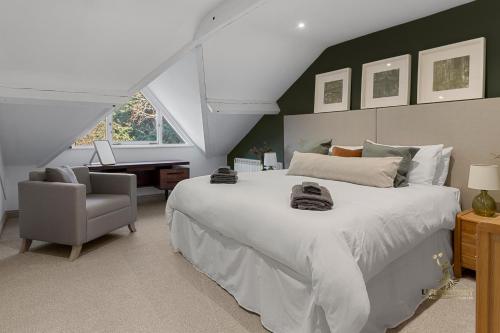 a bedroom with a large white bed and a desk at Luxe Courtyard Apartment for 4 Near Exeter City Centre in Exeter