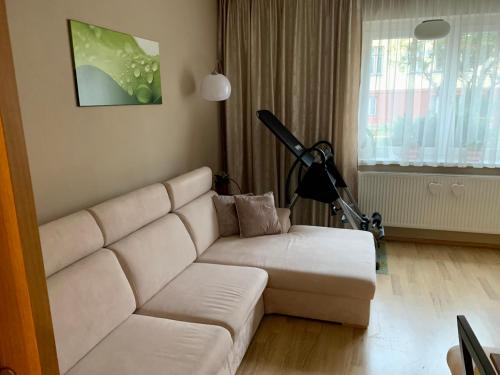 a living room with a white couch and a lamp at Park - apartmány na prenájom in Nové Mesto nad Váhom