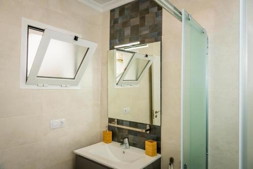 a bathroom with a sink and a mirror at Dolmen de Viera in Antequera