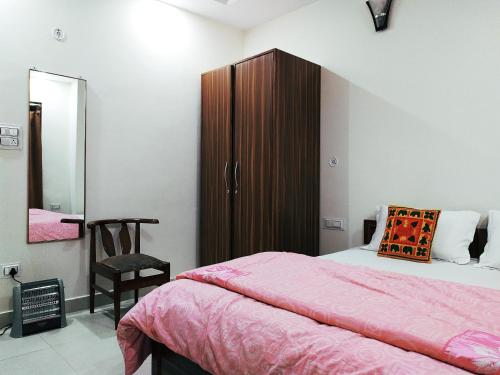 a bedroom with a bed and a wooden cabinet at Shimla Gypsy - Home Stay in Shimla