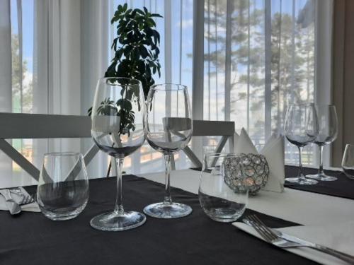 a group of wine glasses sitting on a table at Usmas muiža in Usma