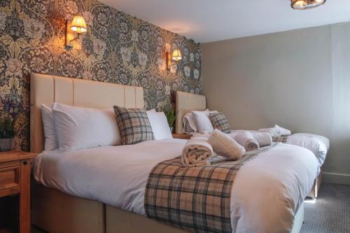a bedroom with two beds with stuffed animals on it at Black Lion Hotel Richmond in Richmond