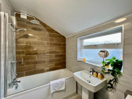 a bathroom with a sink and a shower and a tub and a sink at Bramhall House - Tranquil Escape Hideaway in Cleethorpes