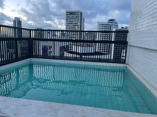 a swimming pool with a view of the city at Boa Viagem - Charmoso apartamento para casais in Recife