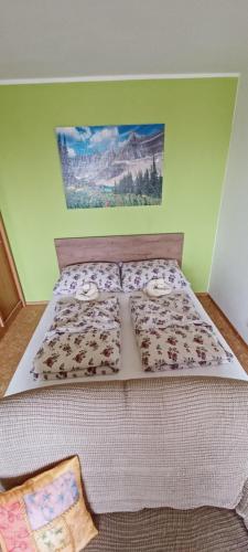 a bed in a bedroom with a bedspread with animals on it at Apartmán Kováčová - The Apartment in spa village in Kováčová