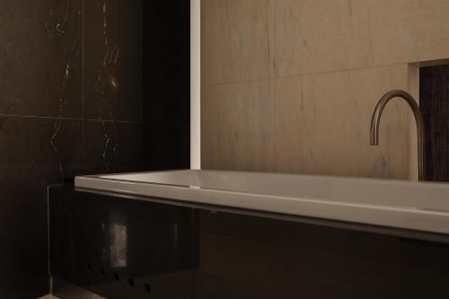a bathroom with a white sink and a mirror at Hotel Monopol in Wrocław