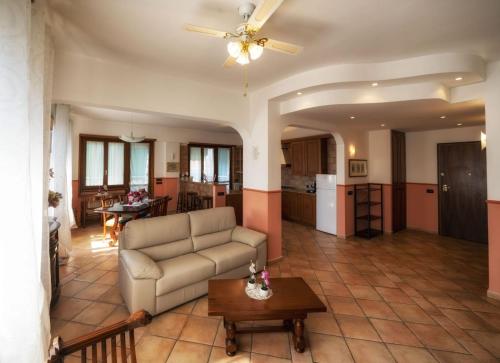 a living room with a couch and a table at Affittacamere Le Palme in Ospedaletti