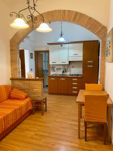 a living room with a couch and a table at Holiday House Ginevra in Formia