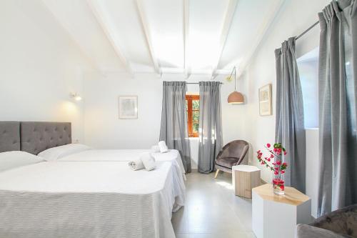 1 dormitorio con 2 camas y 1 silla en Pollensa - 35268 Mallorca en Pollensa