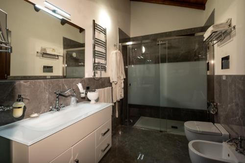 a bathroom with a sink and a shower and a toilet at Villa del Gattopardo in Palermo