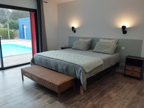 a bedroom with a bed and a swimming pool at Les Naiades in Dolus-d'Oléron