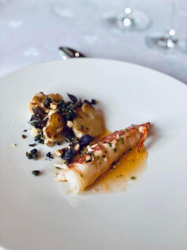 a white plate with a piece of food on it at Engø Gård Hotel & Restaurant in Tjøme