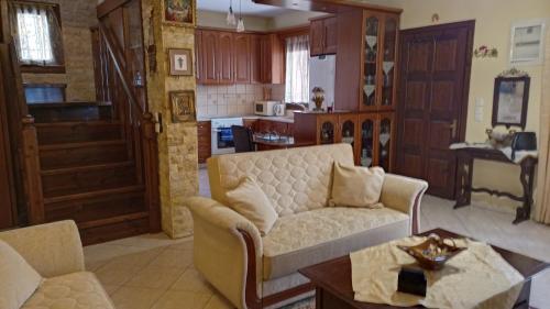 a living room with a couch and a table at VILLA MALILA in Panayia