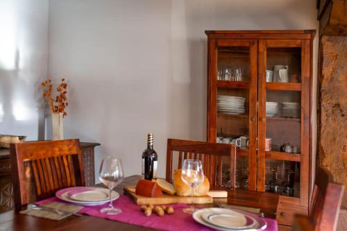 a dining room table with two plates and wine glasses at Casa rural Enekoizar in Abaurrea Alta