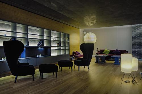a living room with chairs and a couch at Link124 Hotel in Parma