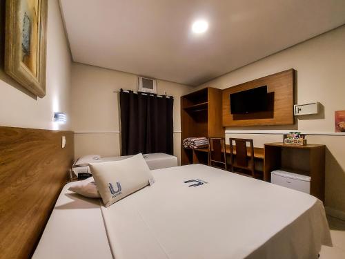 a hotel room with a bed and a dining room at Hotel Itamarati Centro-República in Sao Paulo
