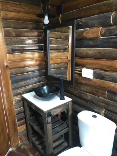 y baño con lavabo y aseo. en Complejo Las Lechuzas Cabaña 1 en San Miguel del Monte