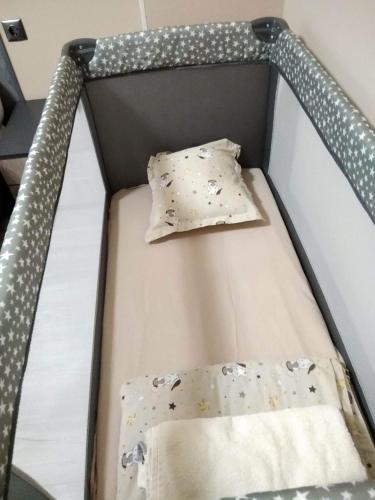 a bed with two pillows on top of it at Апартамент Рая 2 in Dobrich