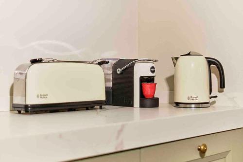 zwei Toaster und ein Toaster und eine Kaffeemaschine auf der Theke in der Unterkunft CASA OTTO @ BELVEDERE PANORAMIC VIEW POINT in La Morra