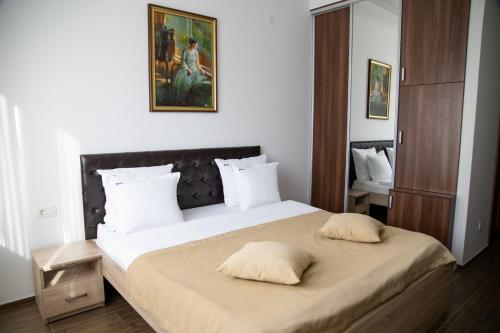a bedroom with a large bed with two pillows on it at Motel Celebic in Podgorica
