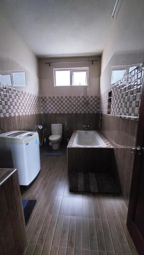 a large bathroom with a tub and a toilet at Villa Jehan Tourist Residence in Souillac