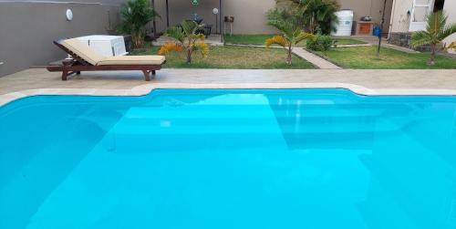 a large blue swimming pool with a chair and a couch at Villa Jehan Tourist Residence in Souillac