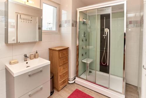 La salle de bains est pourvue d'une douche et d'un lavabo. dans l'établissement Chambres à louer dans appartement Balcon - wifi - parking gratuit, à Nevers
