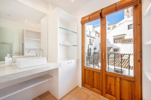 a bathroom with a sink and a window at Porta Nova Suites Altea - Adults Only in Altea